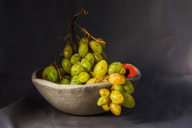 istock still life of a bunch of grapes in a cup inside glazed with red 1338475855