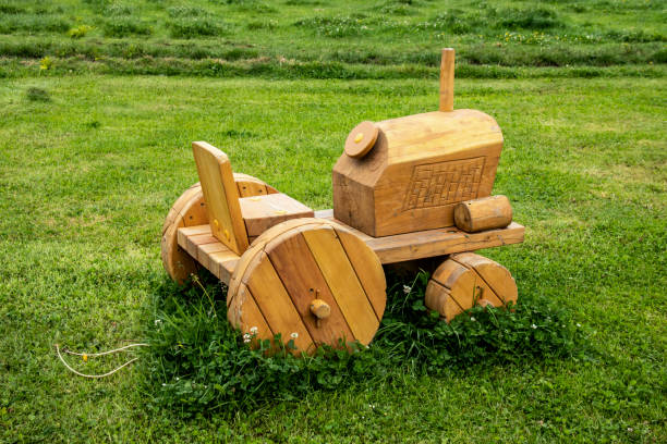 Wooden tractor with trailer, transports small trees. Concept of safeguarding nature and the environment and deforestation. Concept of zero toxic emissions in the air.