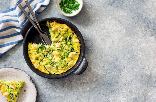 Cheesy zucchini, potatoes and greens casserole stock photo