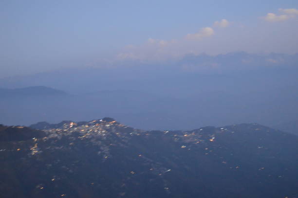 Tiger Hill Darjeeling At sunrise, the peaks of Kanchenjunga are illuminated before the sun is seen at lower elevations. From Tiger Hill, Mount Everest (8848 m) is just visible. Kanchenjunga (8598 m) looks higher than Mt. Everest, owing to the curvature of the Earth, as it is several miles closer than Everest. The distance in a straight line from Tiger Hill to Everest is 107 miles (172 km).
On a clear day, Kurseong is visible to the south and in the distance, along with Teesta River, Mahananda River, Balason River and Mechi River meandering down to the south. Chumal Rhi mountain of Tibet, 84 miles (135 km) away, is visible over the Chola Range
Senchel Wildlife Sanctuary is close to Tiger Hill. tiger hill stock pictures, royalty-free photos & images