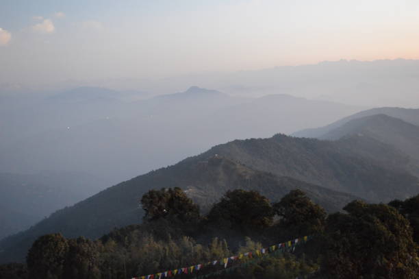 Tiger Hill Darjeeling At sunrise, the peaks of Kanchenjunga are illuminated before the sun is seen at lower elevations. From Tiger Hill, Mount Everest (8848 m) is just visible. Kanchenjunga (8598 m) looks higher than Mt. Everest, owing to the curvature of the Earth, as it is several miles closer than Everest. The distance in a straight line from Tiger Hill to Everest is 107 miles (172 km).
On a clear day, Kurseong is visible to the south and in the distance, along with Teesta River, Mahananda River, Balason River and Mechi River meandering down to the south. Chumal Rhi mountain of Tibet, 84 miles (135 km) away, is visible over the Chola Range
Senchel Wildlife Sanctuary is close to Tiger Hill. tiger hill stock pictures, royalty-free photos & images