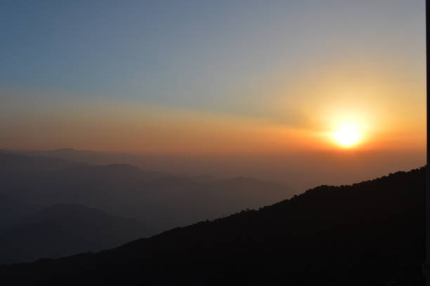 Sunrise at Tiger Hill Darjeeling At sunrise, the peaks of Kanchenjunga are illuminated before the sun is seen at lower elevations. From Tiger Hill, Mount Everest (8848 m) is just visible. Kanchenjunga (8598 m) looks higher than Mt. Everest, owing to the curvature of the Earth, as it is several miles closer than Everest. The distance in a straight line from Tiger Hill to Everest is 107 miles (172 km).
On a clear day, Kurseong is visible to the south and in the distance, along with Teesta River, Mahananda River, Balason River and Mechi River meandering down to the south. Chumal Rhi mountain of Tibet, 84 miles (135 km) away, is visible over the Chola Range
Senchel Wildlife Sanctuary is close to Tiger Hill. tiger hill stock pictures, royalty-free photos & images