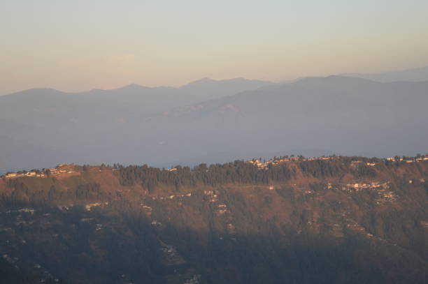 Tiger Hill Darjeeling At sunrise, the peaks of Kanchenjunga are illuminated before the sun is seen at lower elevations. From Tiger Hill, Mount Everest (8848 m) is just visible. Kanchenjunga (8598 m) looks higher than Mt. Everest, owing to the curvature of the Earth, as it is several miles closer than Everest. The distance in a straight line from Tiger Hill to Everest is 107 miles (172 km).
On a clear day, Kurseong is visible to the south and in the distance, along with Teesta River, Mahananda River, Balason River and Mechi River meandering down to the south. Chumal Rhi mountain of Tibet, 84 miles (135 km) away, is visible over the Chola Range
Senchel Wildlife Sanctuary is close to Tiger Hill. tiger hill stock pictures, royalty-free photos & images