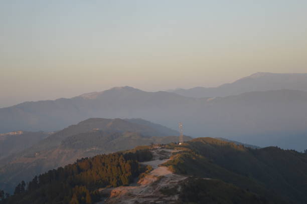 Tiger Hill Darjeeling At sunrise, the peaks of Kanchenjunga are illuminated before the sun is seen at lower elevations. From Tiger Hill, Mount Everest (8848 m) is just visible. Kanchenjunga (8598 m) looks higher than Mt. Everest, owing to the curvature of the Earth, as it is several miles closer than Everest. The distance in a straight line from Tiger Hill to Everest is 107 miles (172 km).
On a clear day, Kurseong is visible to the south and in the distance, along with Teesta River, Mahananda River, Balason River and Mechi River meandering down to the south. Chumal Rhi mountain of Tibet, 84 miles (135 km) away, is visible over the Chola Range
Senchel Wildlife Sanctuary is close to Tiger Hill. tiger hill stock pictures, royalty-free photos & images