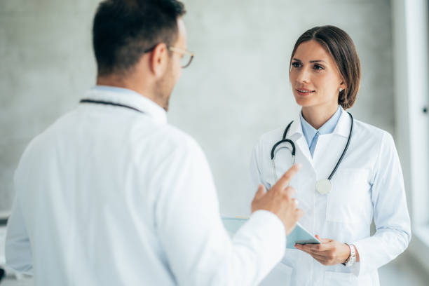 istock Two healthcare workers talking at hospital 1338482427