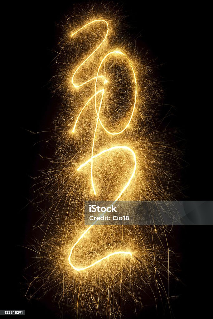 year 2012 written in sparkling letters Vertical composition on black background 2012 Stock Photo