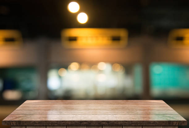 istock Empty wooden table top with lights bokeh on blur restaurant background 1338483866