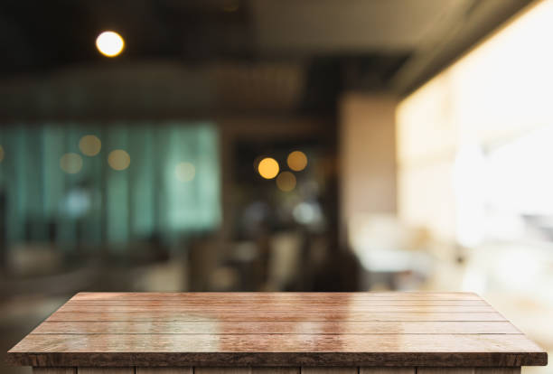 istock Empty wooden table top with lights bokeh on blur restaurant background 1338483870