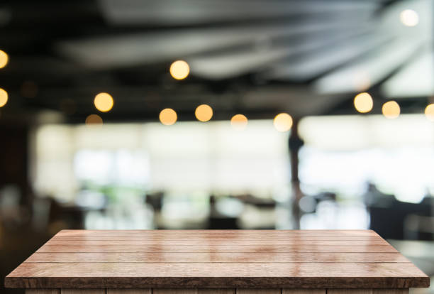 istock Empty wooden table top with lights bokeh on blur restaurant background 1338483880