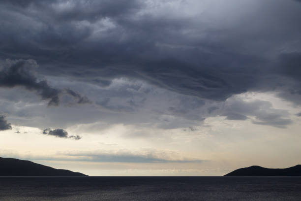 istock Dark dramatic sky with stormy clouds over sea 1338485840