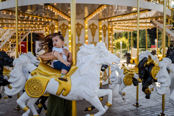 Baby Boy riding Carousel Horse for the first time