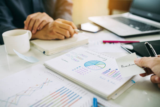 istock businessman working on project for analyzing company financial report balance statement with documents graphics at modern office space. Concept picture of business,economy, market,money and tax. 1338494550