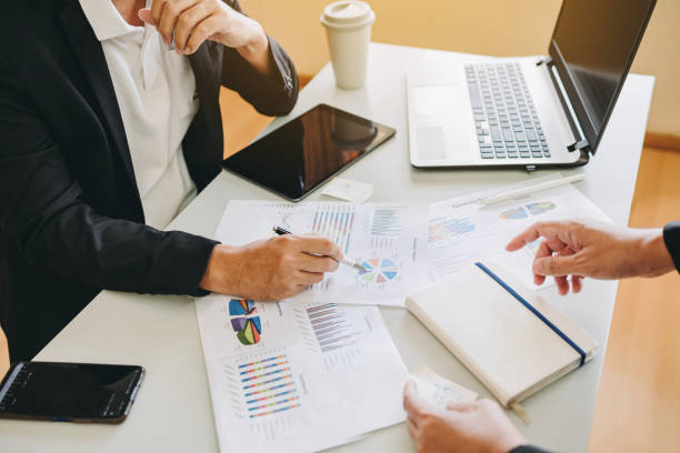 istock businessman working on project for analyzing company financial report balance statement with documents graphics at modern office space. Concept picture of business,economy, market,money and tax. 1338494558