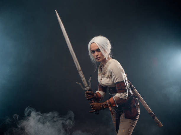 istock A young warrior with a sword on a dark background. Fantasy heroine 1338495641