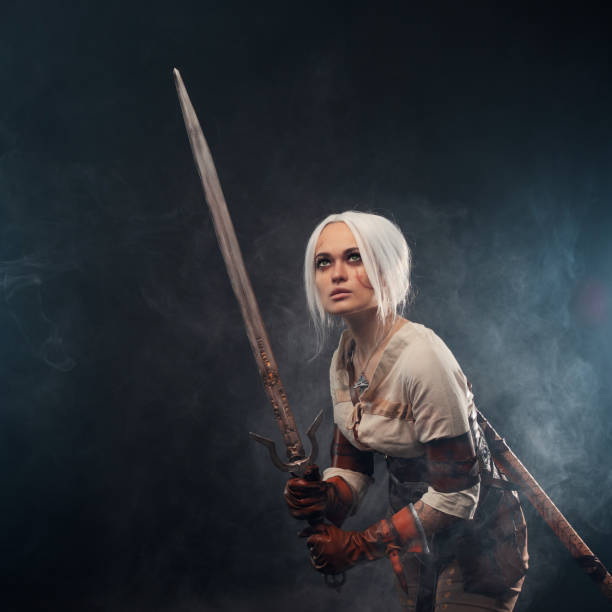 istock A young warrior with a sword on a dark background. Fantasy heroine 1338495652
