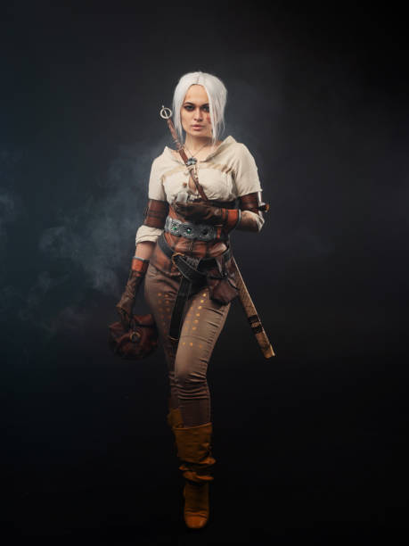 istock A young warrior with a sword on a dark background. Fantasy heroine 1338495679