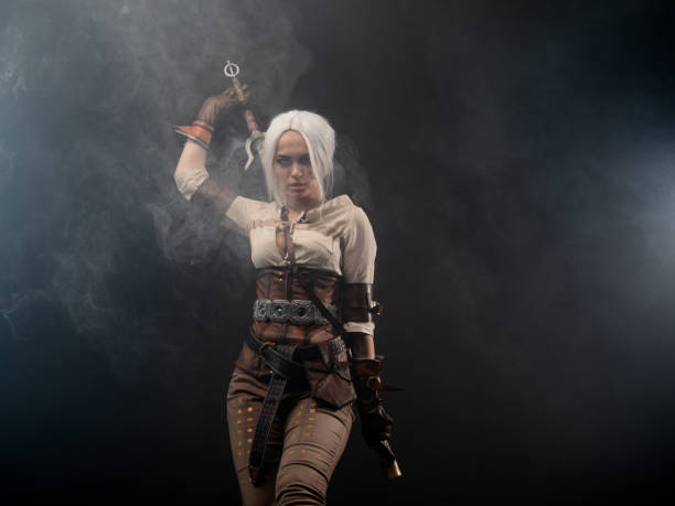 istock A young warrior with a sword on a dark background. Fantasy heroine 1338495685