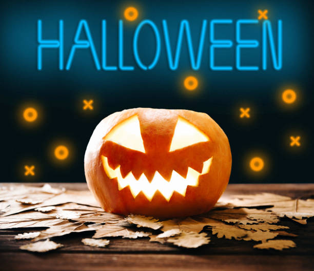 istock Glowing jack-o-lantern pumpkin and neon sign Halloween. 1338496745