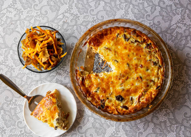 Salty pie or quiche made with Craterellus lutescens or Cantharellus lutescens or Cantharellus xanthopus or Cantharellus aurora, commonly known as Yellow Foot, is a species of mushroom. Salty pie or quiche made with Craterellus lutescens or Cantharellus lutescens or Cantharellus xanthopus or Cantharellus aurora, commonly known as Yellow Foot, is a species of mushroom. cantharellus tubaeformis stock pictures, royalty-free photos & images