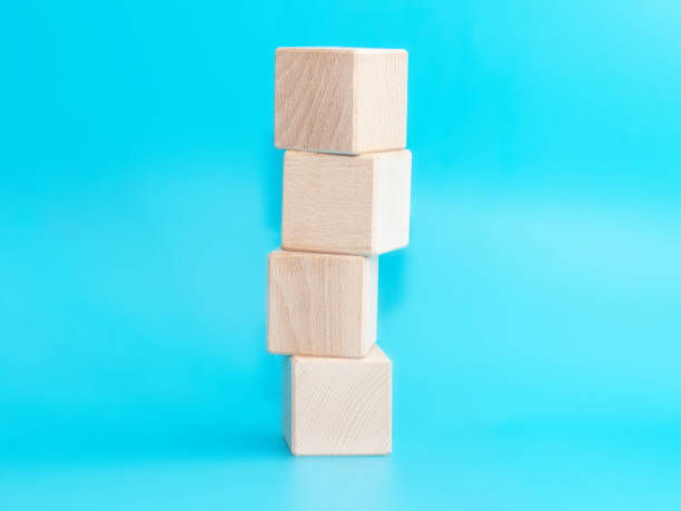 istock Wooden cube on blue background with space for text 1338499958