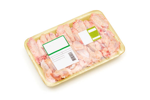 istock Raw chicken wings packed in a styrofoam plate with a label on white background. 1338501092