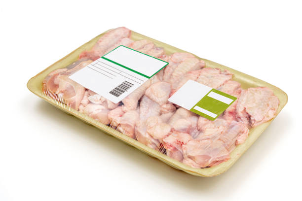 istock Raw chicken wings packed in a styrofoam plate with a label on white background. 1338501164