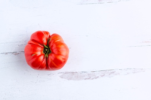 Heirloom organic tomato over a wooden surface from above