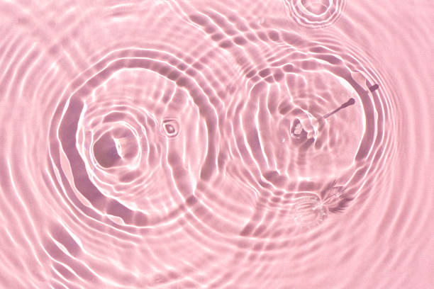 istock Splashes on pink water under sunlight. Top view, flat lay 1338502959