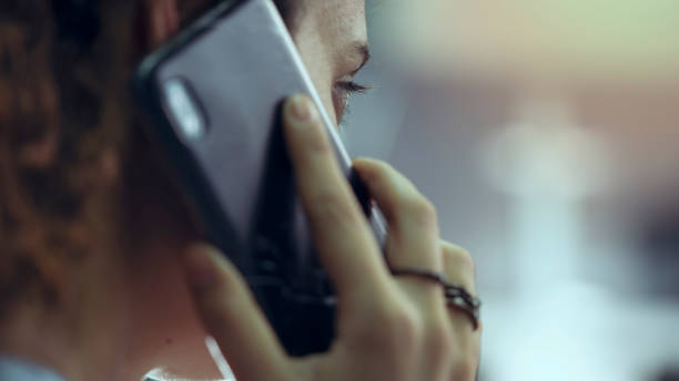 Woman talking on a cellphone stock photo