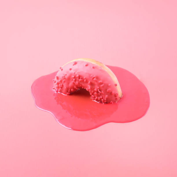 istock Creative food concept. Pink donut melts on a pink background. 1338505711