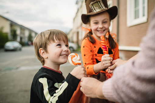 Little boy and girl trick or treating