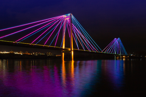 Artistic night view on colorful illuminated of suspension bridge in Krasnoyarsk, Russia