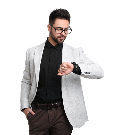 Young businessman checking time on white background