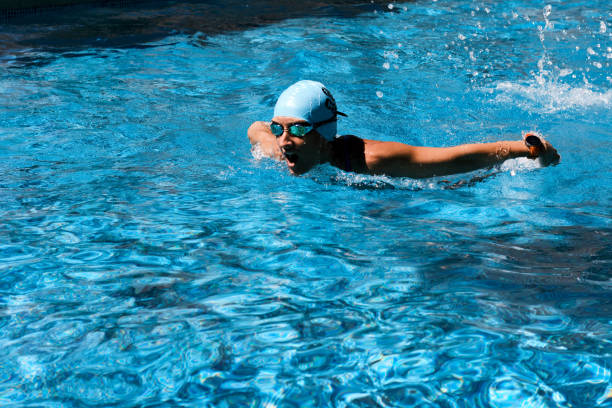 istock Young woman training at the swimming pool 1338508147