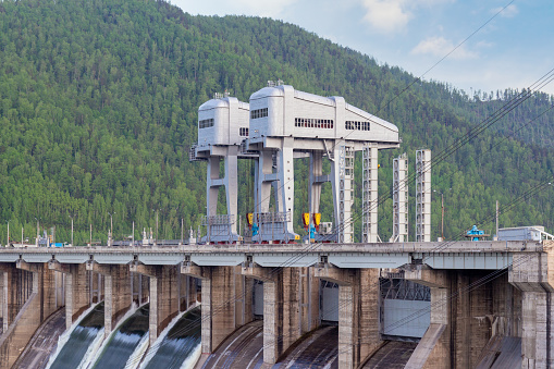View on giant gantry cranes to hydroelectric power station of Krasnoyarsk dam located on the Yenisey River near Krasnoyarsk in Divnogorsk, Russia.