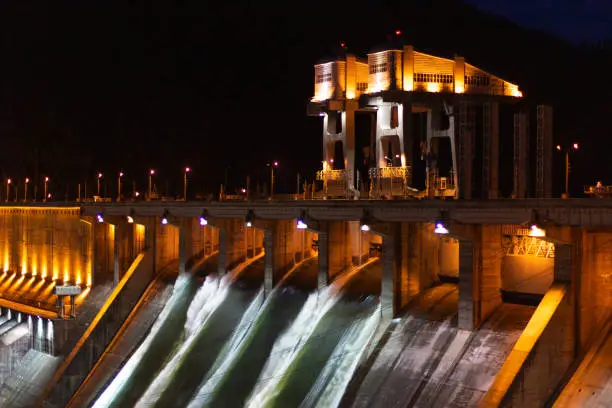 Photo of Water discharge to hydroelectric power station. Industrial landscape with open locks on Krasnoyarsk Dam