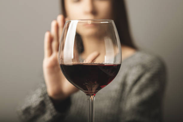 reject liquor,stop alcohol, teenager girl shows a sign of refusal of wine reject liquor,stop alcohol, teenager girl shows a sign of refusal of wine alcohol abuse stock pictures, royalty-free photos & images