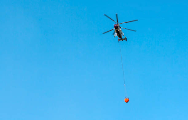 istock Fire helicopter carrying water to forest fire 1338511042