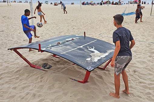 Brazil - Rio de Janeiro, September 5th. 2021 - Two teenagers practicing futmesa in Flamengo Beach. Official soccer ball must be used and the ball must never be touched with the hands or arms