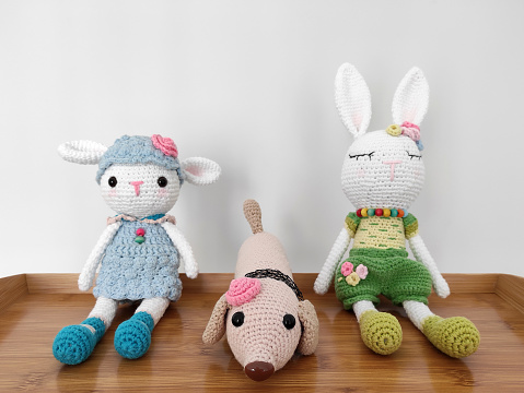 Amigurumi toy, cute little lamb, rabbit and dog soft knitted toys on white background
