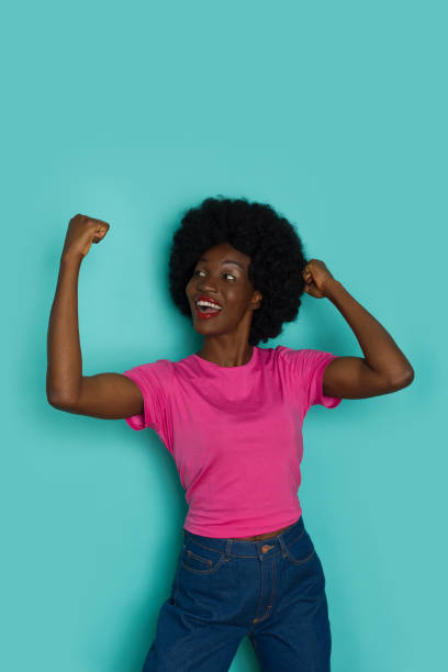 istock Excited Young Black Woman Is Cheering With Arms Raised 1338515819