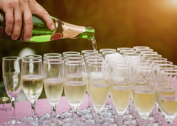 istock The waiter in pours the champagne 1338516175