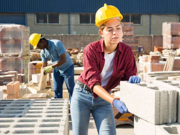 istock Woman checking quality of bricks at construction store 1338517002