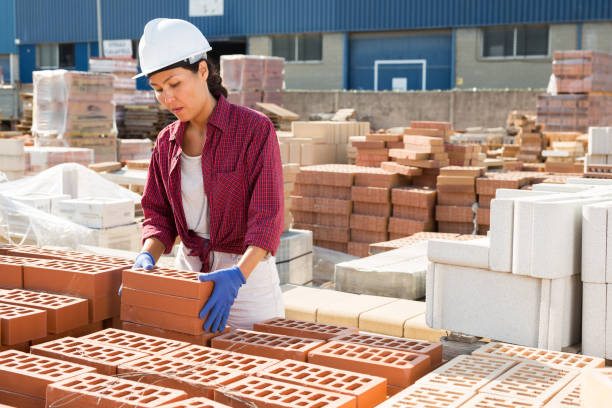 istock Attentive asian woman is laying bricks 1338517019