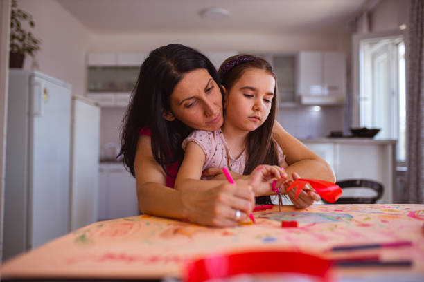 mother and daughter together making a poster about breast cancer awareness - community outreach connection child paper imagens e fotografias de stock