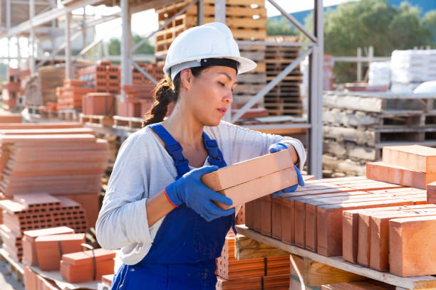 istock Asian female calculating bricks before selling 1338517329