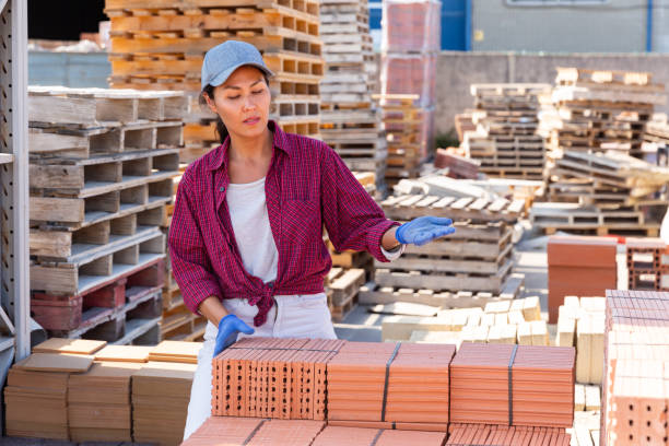 istock Asian worker stacking bricks in warehouse of building materials on an open-air site 1338517716