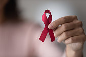 Close up focus on red ribbon in female hands