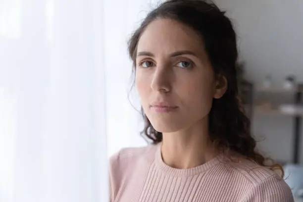 Photo of Close up portrait of serious joyless female