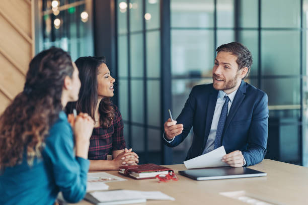 Businessman explaining his ideas Group of business persons during a meeting in the office business consultation stock pictures, royalty-free photos & images